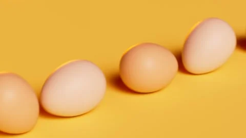Rolling eggs on a yellow pastel background. Happy Easter. Spring celebration. Stock Footage 158245765