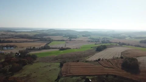Rolling farmland and patchwork fields stretching toward distant hills 스톡 동영상 311969541