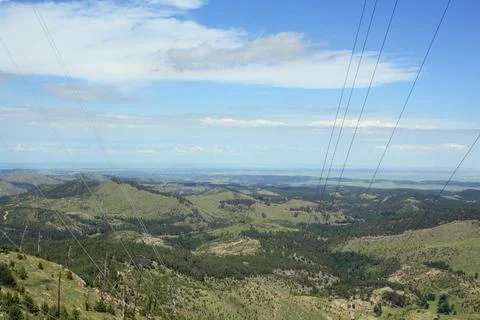 Rolling Forested Hills and Distant Mountain Horizons Under Clear Sky Stock Photos