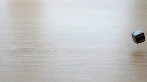 Rolling a four and a two with a pair of black gambling dice on a table in slow Stock Footage 109138801