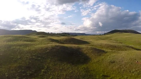 ROLLING GRASSLANDS filmed with DRONE on SUNNY DAY Stock Footage