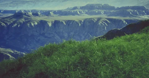 Rolling green hills overlooking dramatic cliffs in a serene landscape Stock Footage 306122710