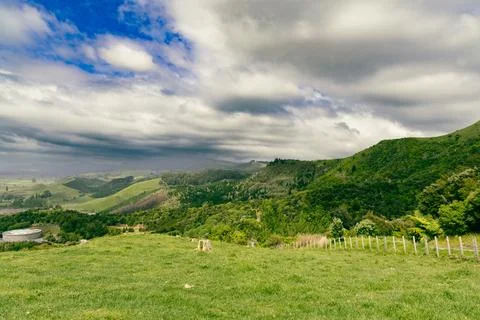 Rolling Green Hills Under Dramatic Cloudy Sky 스톡 사진