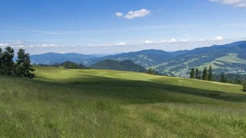 Rolling Green Meadows and Mountain Panorama in Małe Pieniny, Poland Stock Photos
