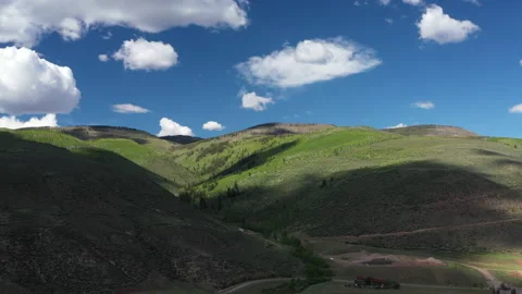 Rolling Green Mountain Hills Under Blue Sky with Clouds Stock Footage 160716804