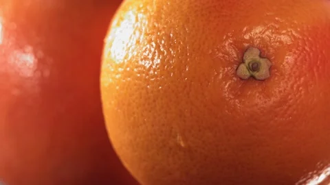 Rolling half of Fresh Grapefruit and opening the inside of the fruit in Slow Stock Footage 199133228