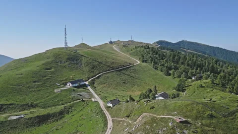 Rolling hills with alpine huts and antenna masts on Nevegal ridge, Italy Stock Footage 318778099