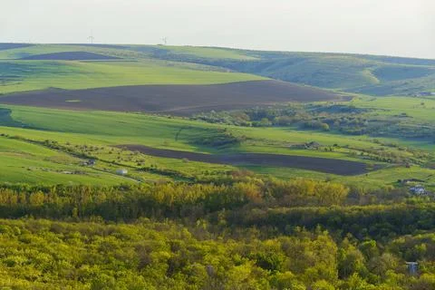 Rolling hills and fields stretch across the landscape in a rural area durin.. Stock Photos