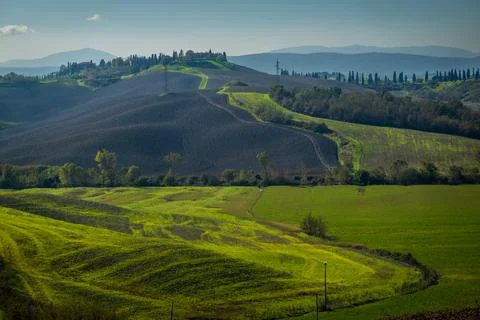 Rolling hills and vibrant fields in picturesque autumn countryside landscape Stock Photos