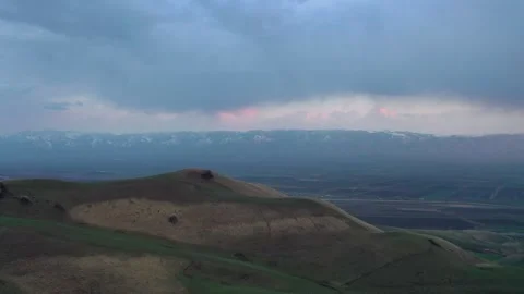 Rolling Hills Distant Snow Mountains Dawn Aerial Wide Stock Footage 339795852
