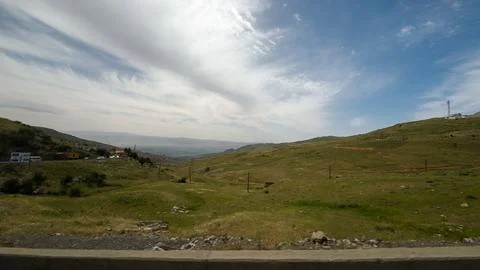 Rolling Hills Under Cloudy Sky Stock Photos