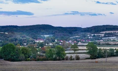 Rolling hills yellow fields and distant castle under cloudy sky in Burgundy.. Stock Photos
