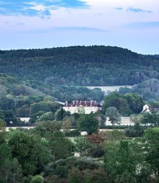 Rolling hills yellow fields and distant castle under cloudy sky in Burgundy.. Stock Photos