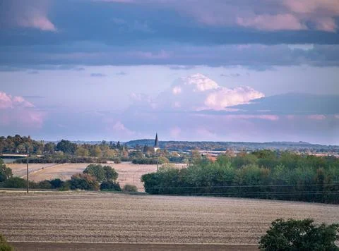Rolling hills yellow fields and distant castle under cloudy sky in Burgundy.. Stock Photos