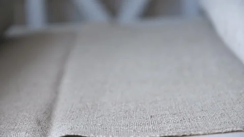 Rolling homemade gray linen into a scroll Stock Footage 137643335