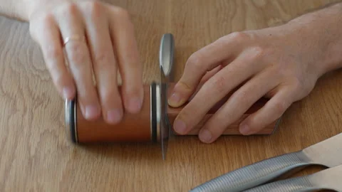 Rolling knife sharpener system maintaining a precise angle for a perfect edge Stock Footage 315209430