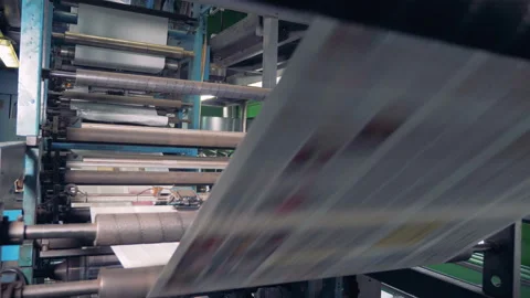 Rolling machine in a print office, close up. Newspaper printed on a printing Stock Footage 94214972