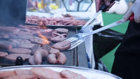 Rolling meat on a barbecue in a nice day Stock Footage 72616472