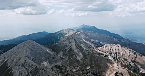 Rolling mountain ridges extend horizon Stock Footage 303301808