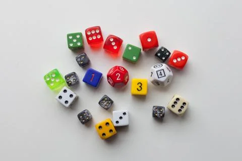 Rolling multi colored game dice Stock Photos