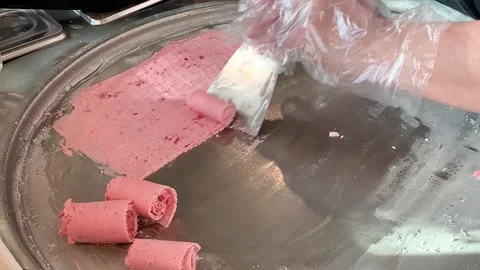Rolling natural strawberry fruit ice cream in Thai style at freeze pan. Homemade Stock Footage 149336946