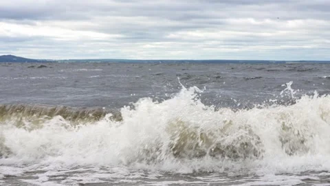 Rolling Ocean Waves Crashing Against the Shore Under a Moody Overcast Sky Stock Footage 346052020
