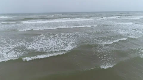 Rolling Ocean Waves Crashing on Sandy Beach on Overcast Day Stock Footage 335636551