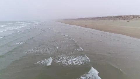 Rolling Ocean Waves Crashing on Sandy Beach on Overcast Day Stock Footage 335636552
