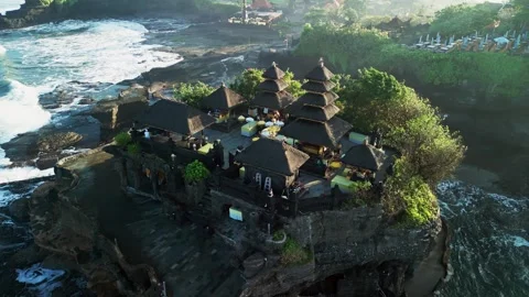 Rolling Ocean Waves Surrounding Tanah Lot Temple in Early Morning Light, Aerial Stock-Footage 337506890