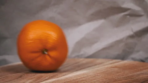 Rolling Orange on Wooden Surface Video stock 265002359