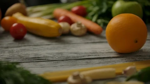 Rolling orange on wooden table. Stock Footage 121593184