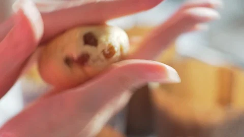 Rolling out the dough ball close-up in the women's hands. Cooking baking in a Stock Footage 128950013