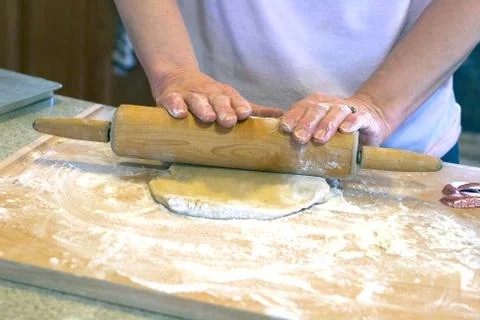 Rolling out dough hands on pin Stock Photos