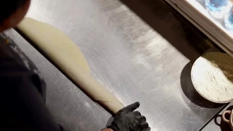 Rolling out the dough on a metal table is the stage of making perfect bread  스톡 동영상 301315158
