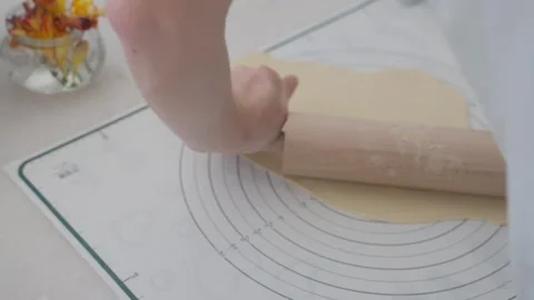 Rolling out dough for pastry is enjoyable and satisfying for home cooks in the Stock Footage 306413114