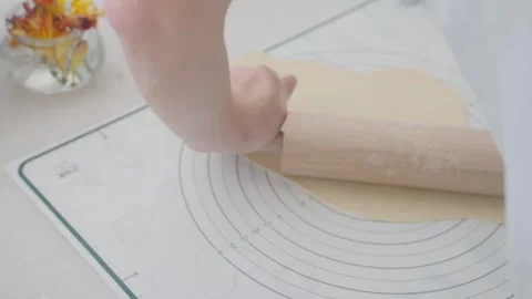 Rolling out dough pastry is enjoyable and satisfying for cooks in the kitchen Stock Footage 306679586