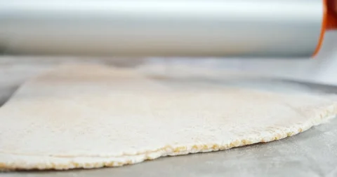Rolling out dough with pin, special dough with layers for homemade pasta. Video stock 133392371