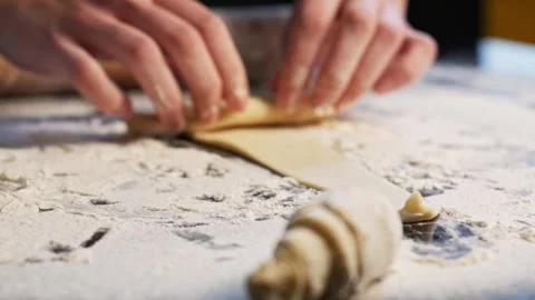Rolling out dough in process of making croissants Stock Footage 148796791
