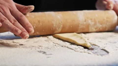 Rolling out dough in process of making croissants Stock Footage 148796853