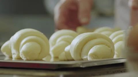 Rolling out dough in process of making croissants. Stock Footage 153164801