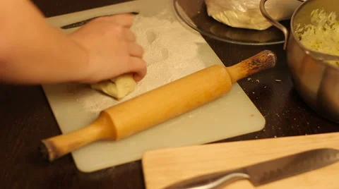Rolling out dough with a rolling pin in hand Stock-Footage 57336437