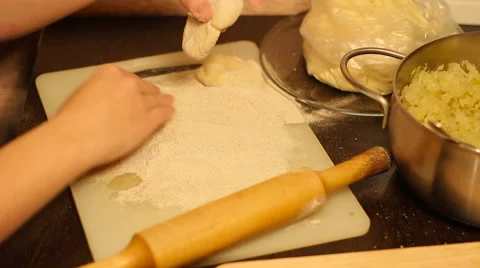 Rolling out dough with a rolling pin in hand Stock Footage 57337355