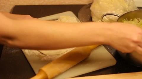 Rolling out dough with a rolling pin in hand Stock Footage 57338313