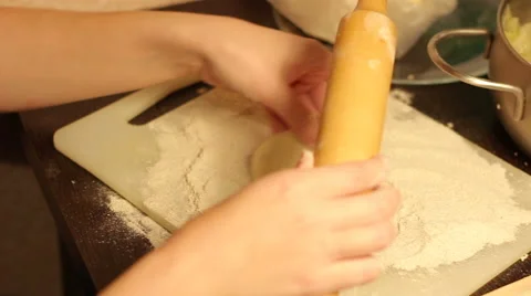 Rolling out dough with a rolling pin in hand Video stock 57342714