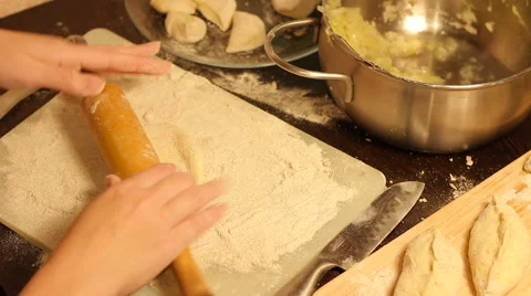 Rolling out dough with a rolling pin in hand Stock Footage 57348304