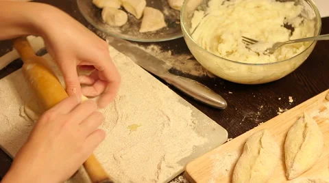 Rolling out dough with a rolling pin in hand Stock Footage 57348997