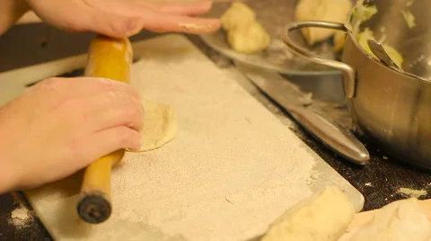 Rolling out dough with a rolling pin in hand Stock Footage 57353256