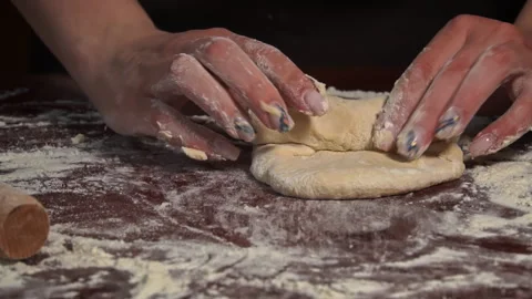 Rolling Out the Dough With a Rolling Pin by Female Hands Close-up Stock Footage 243735714