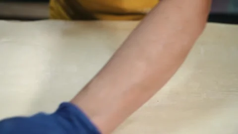 Rolling out the dough with a rolling pin. The process of home baking from wheat Video stock 256108518