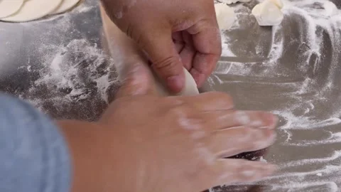 Rolling Out Dough with Rolling Pin Closeup for Traditional Dumplings Stock Footage 340148725